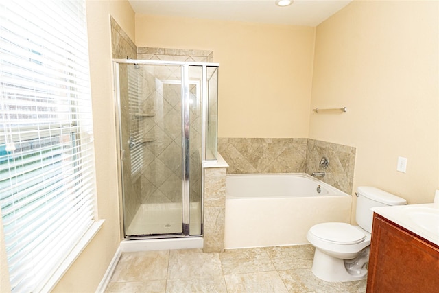 bathroom with a garden tub, a shower stall, vanity, and toilet