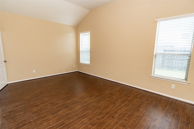 empty room with vaulted ceiling, baseboards, and dark wood-style flooring