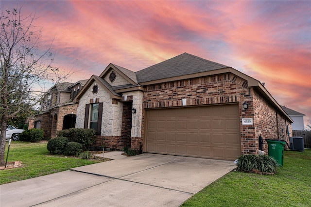 french country home with brick siding, an attached garage, and a front lawn