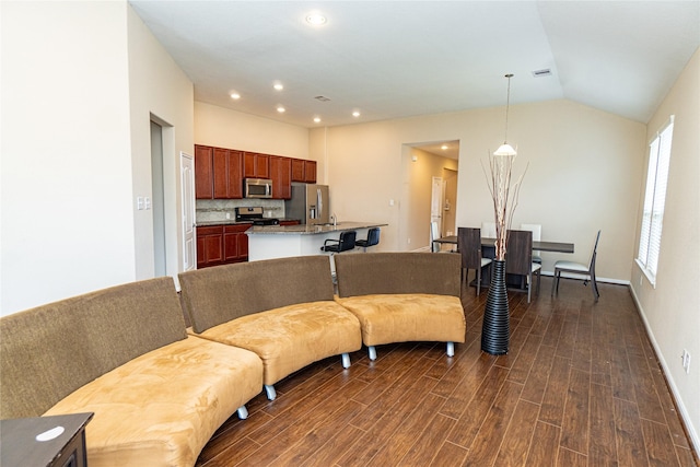 living area featuring visible vents, baseboards, recessed lighting, dark wood-type flooring, and vaulted ceiling