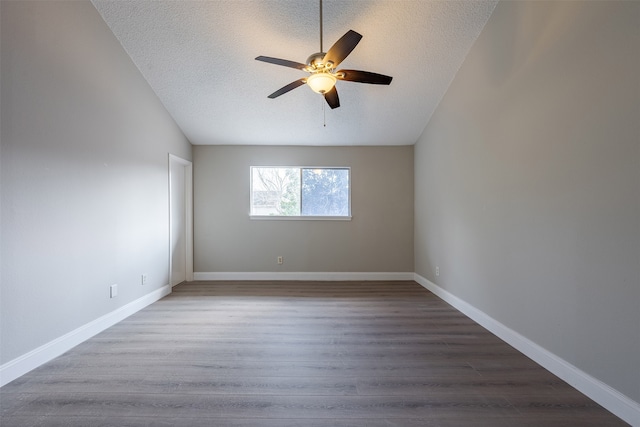 spare room featuring a textured ceiling, a ceiling fan, baseboards, and wood finished floors