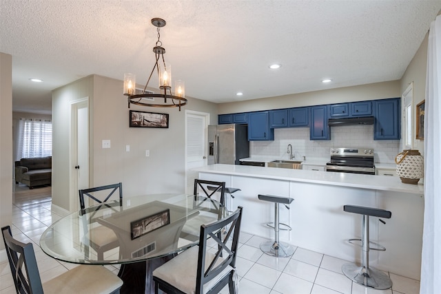 dining room featuring light tile patterned floors, a notable chandelier, a textured ceiling, and recessed lighting