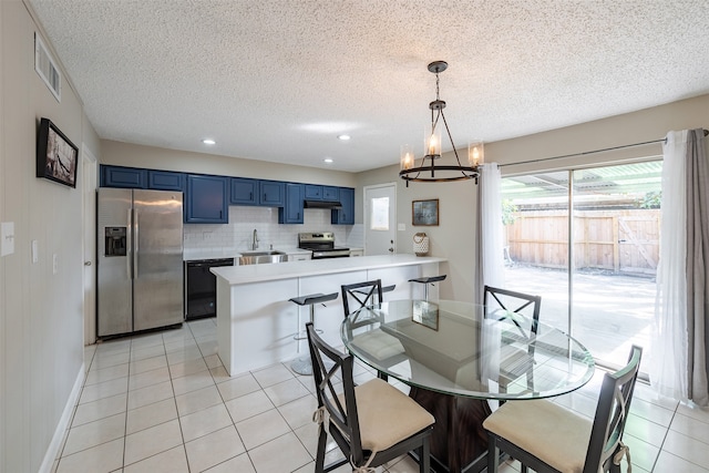 dining space featuring light tile patterned floors, visible vents, and plenty of natural light