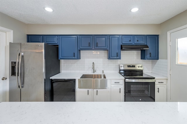 kitchen featuring blue cabinetry, a sink, light countertops, under cabinet range hood, and appliances with stainless steel finishes