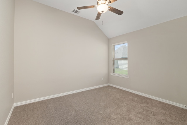 carpeted empty room featuring a ceiling fan, lofted ceiling, baseboards, and visible vents