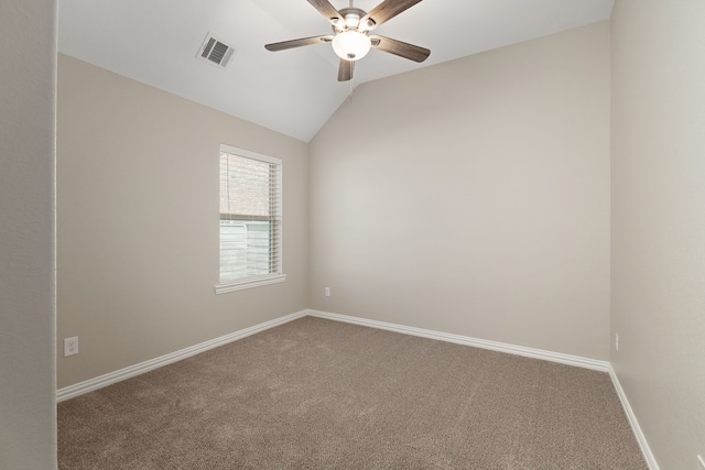 spare room featuring visible vents, baseboards, vaulted ceiling, carpet flooring, and a ceiling fan