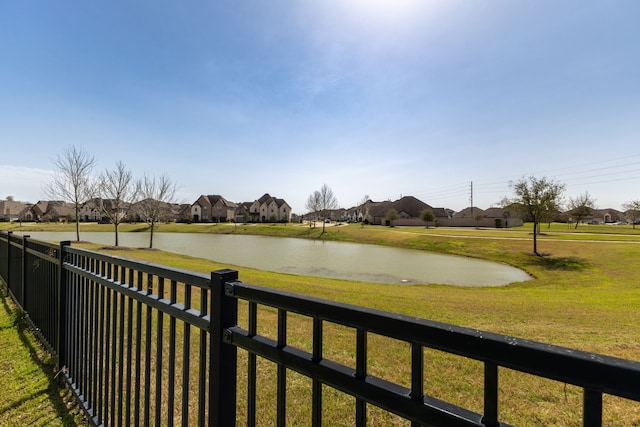 view of water feature with fence and a residential view