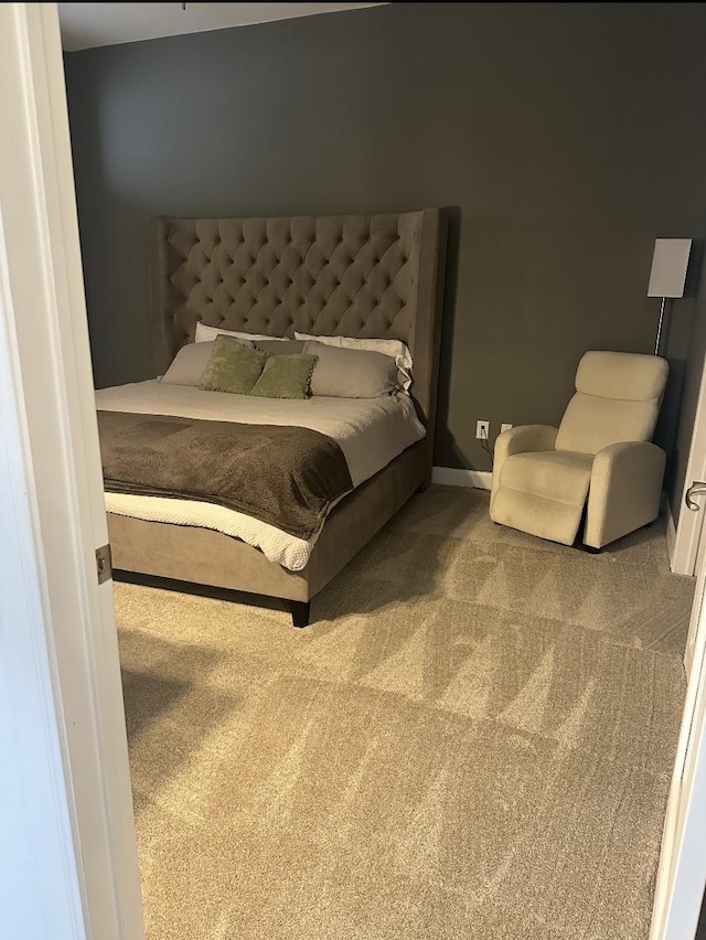 carpeted bedroom featuring baseboards