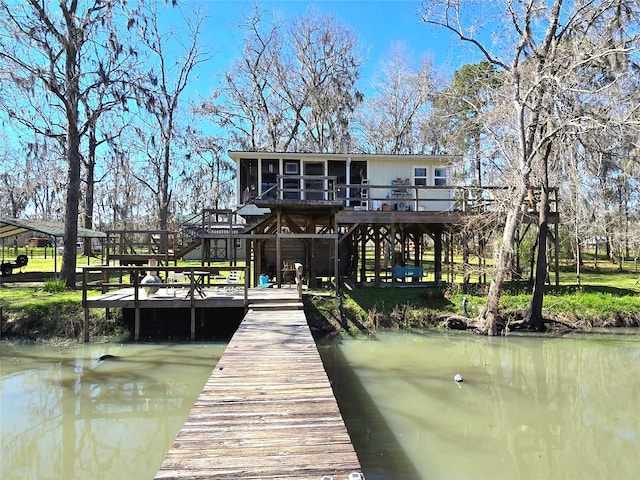 view of dock featuring stairs and a deck with water view