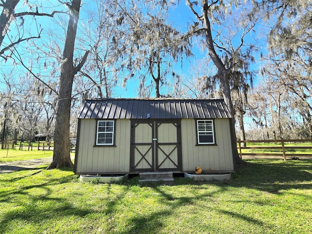 view of shed featuring fence