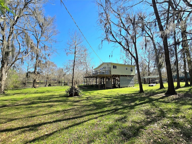 view of yard with a deck and stairway