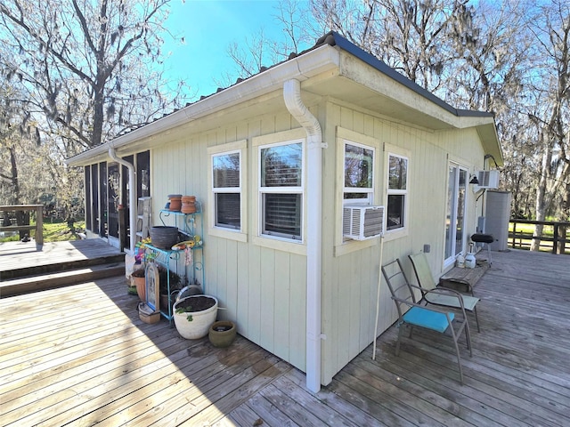 wooden deck featuring cooling unit