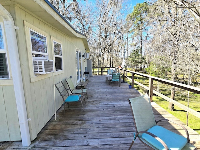 wooden deck featuring cooling unit