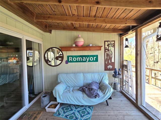 sunroom / solarium with beam ceiling, a healthy amount of sunlight, and wooden ceiling