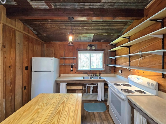 kitchen with a sink, open shelves, white appliances, and wooden walls