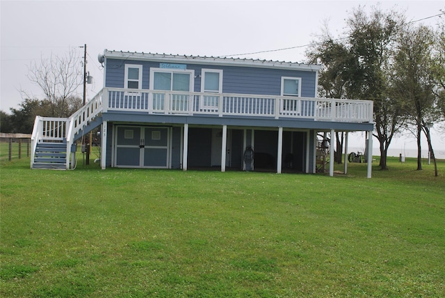 back of house with stairway, a lawn, and a wooden deck