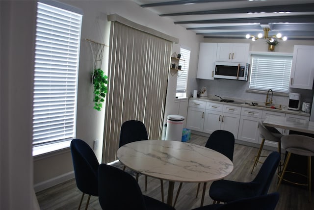 dining space featuring a wealth of natural light, a notable chandelier, and light wood-type flooring