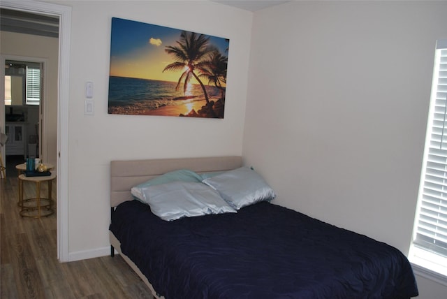 bedroom featuring baseboards and wood finished floors