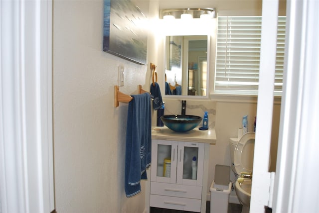 half bathroom featuring toilet and a sink