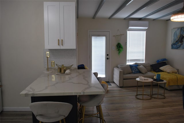 dining space with dark wood-style floors, beam ceiling, and baseboards