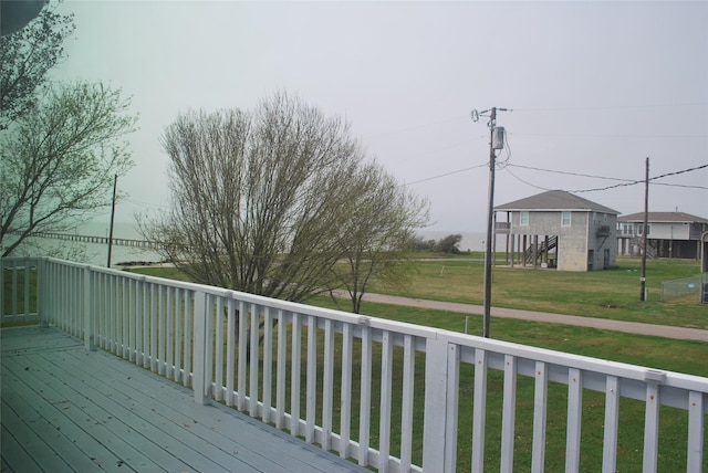 wooden terrace with a lawn