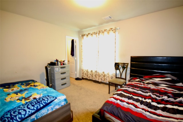 bedroom with visible vents and carpet flooring