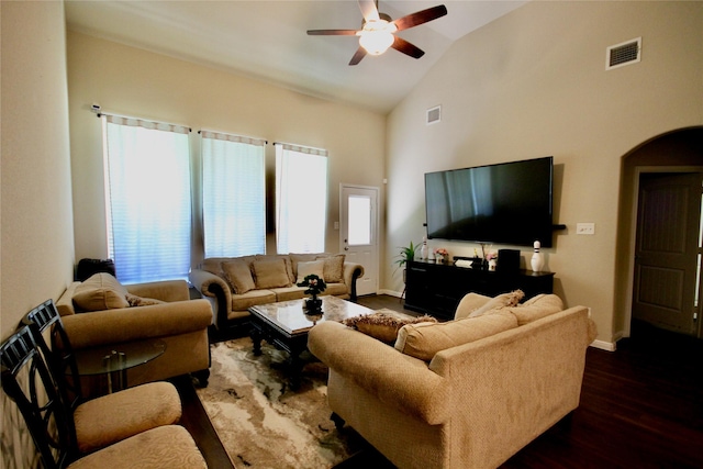 living area featuring dark wood finished floors, vaulted ceiling, baseboards, and visible vents