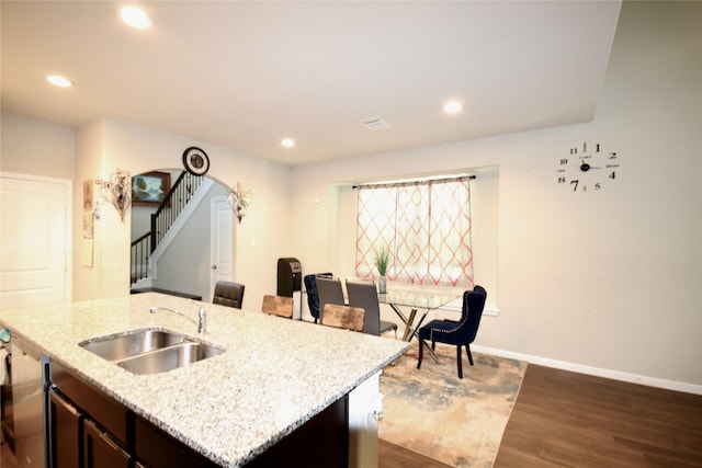 kitchen featuring a sink, dark wood finished floors, recessed lighting, baseboards, and dishwasher