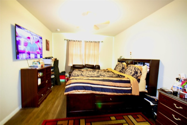 bedroom featuring baseboards and wood finished floors