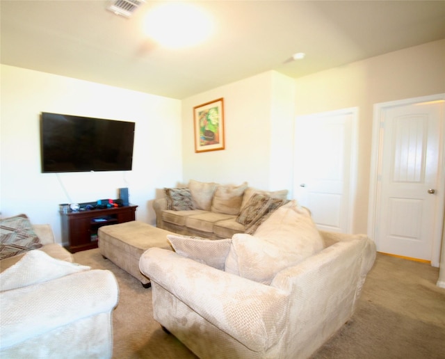 living area featuring light carpet and visible vents