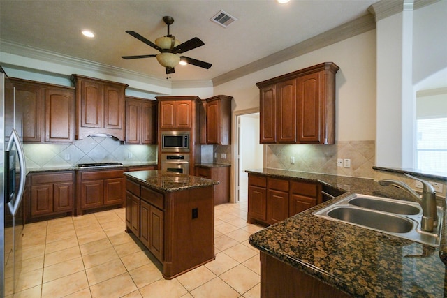 kitchen with visible vents, crown molding, ceiling fan, appliances with stainless steel finishes, and a sink