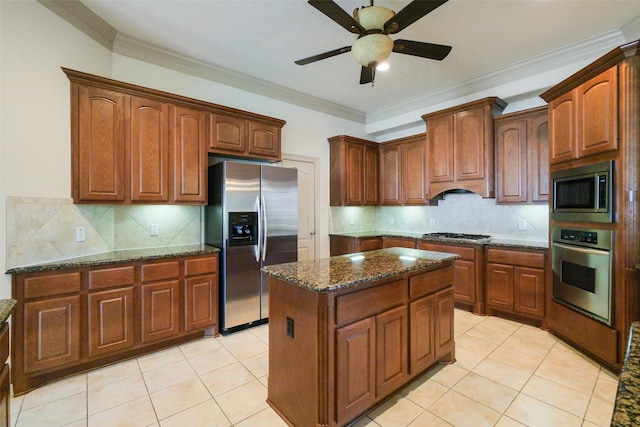 kitchen with a center island, ceiling fan, ornamental molding, light tile patterned flooring, and stainless steel appliances