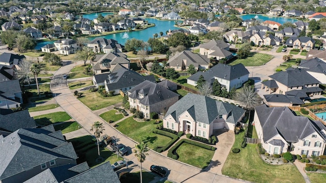 birds eye view of property with a residential view and a water view