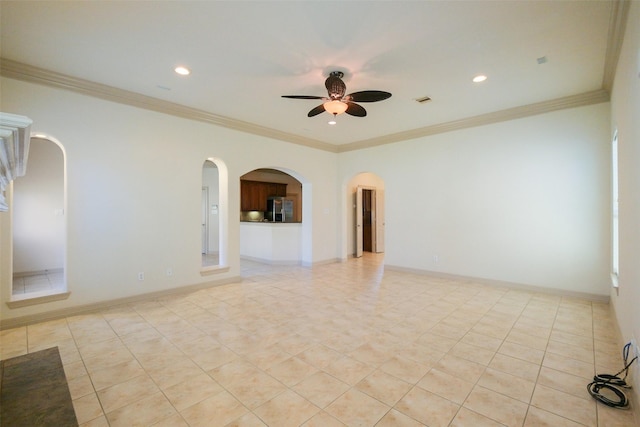 spare room with a ceiling fan, recessed lighting, arched walkways, crown molding, and baseboards