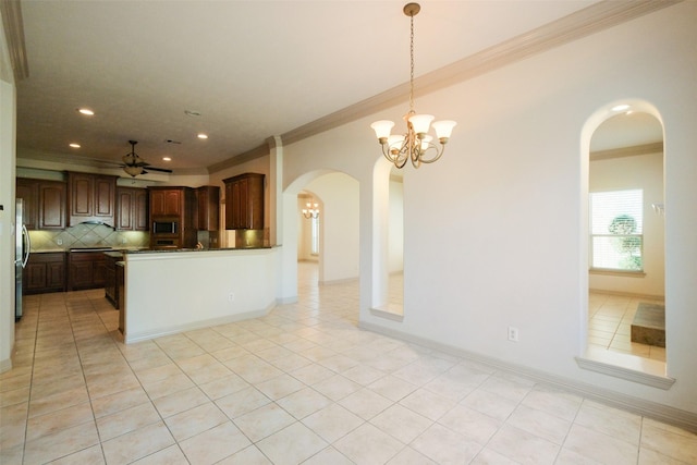 kitchen featuring light tile patterned floors, arched walkways, stainless steel appliances, decorative backsplash, and crown molding