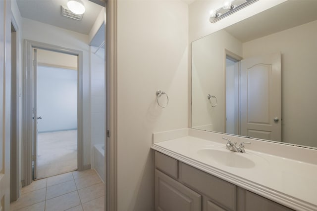 full bathroom with vanity, a bathing tub, visible vents, and tile patterned flooring