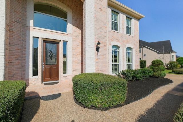 doorway to property with brick siding