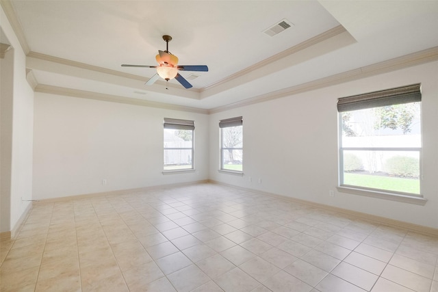 spare room with visible vents, a raised ceiling, ceiling fan, and crown molding