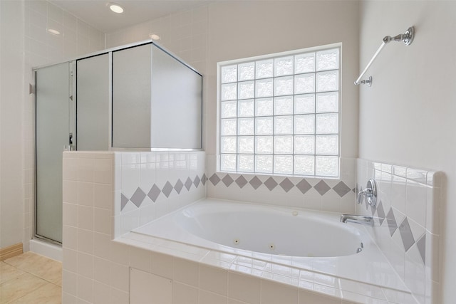 full bath featuring tile patterned flooring, a tub with jets, and a stall shower