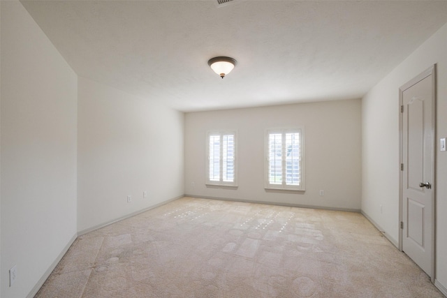 unfurnished room with carpet flooring and baseboards