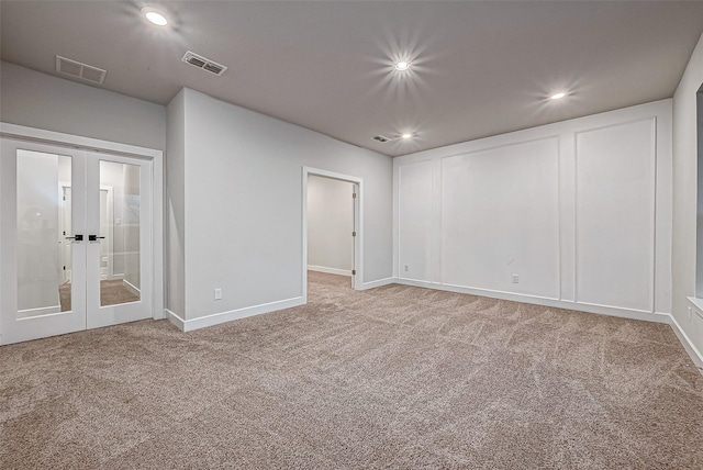 spare room featuring recessed lighting, visible vents, carpet flooring, and french doors