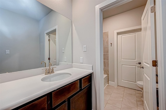 full bathroom featuring toilet, vanity, and tile patterned flooring