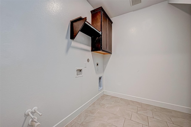 clothes washing area with electric dryer hookup, washer hookup, cabinet space, baseboards, and gas dryer hookup