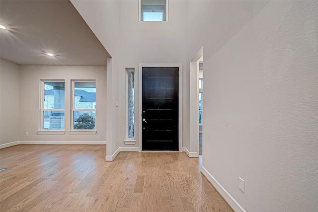 entrance foyer with light wood-style floors and baseboards