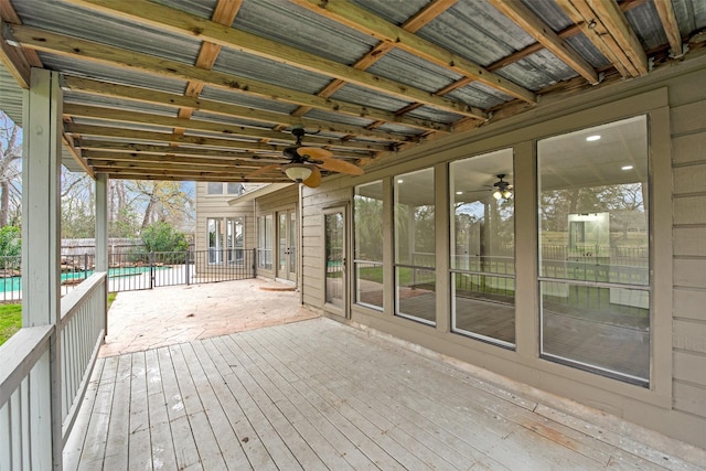 wooden deck with a fenced in pool, ceiling fan, and fence