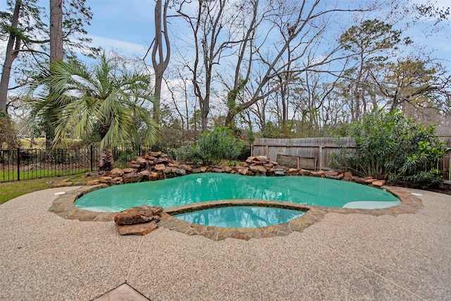 view of swimming pool featuring an in ground hot tub and a fenced backyard