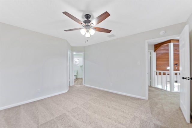 empty room featuring carpet flooring, ceiling fan, and baseboards