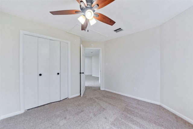 unfurnished bedroom featuring a ceiling fan, baseboards, visible vents, a closet, and carpet flooring