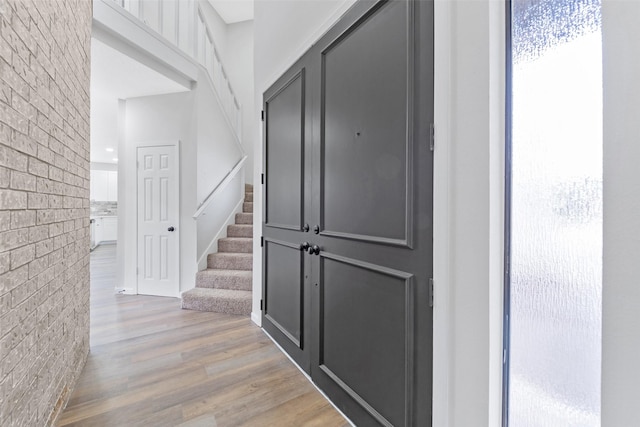 interior space featuring wood finished floors and brick wall