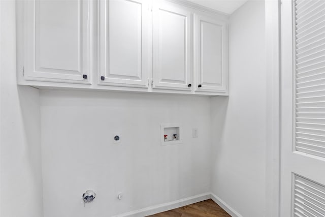 washroom featuring hookup for an electric dryer, washer hookup, cabinet space, baseboards, and gas dryer hookup